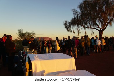 Yulara, Northern Territory, Australia, May 29, 2019. With Tables Cleared Of Canapes People Are Savouring An Uluru Sunset