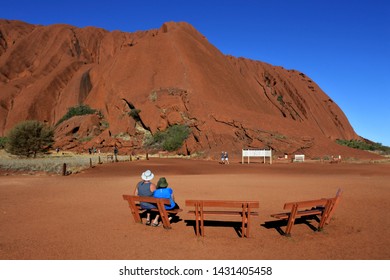 YULARA, NT - MAY 23 2019:Tourist Looking At Uluru (Ayers Rock). Uluru Is Australia's Most Natural Icon And The Focal Point For Australia Of Australian Indigenous People. 