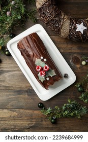  Yule log cake, Christmas buche de Noel, wooden dark background                               - Shutterstock ID 2239684999