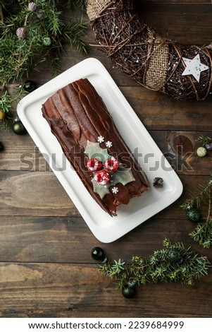  Yule log cake, Christmas buche de Noel, wooden dark background                              