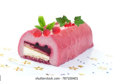 Yule log of white chocolate mousse, stuffed with raspberry puree sponge rolls, glazed with raspberry jelly, garnished with fresh berries, gooseberries and gold leaf (also know as Buche de Noel)