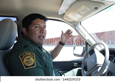 Yuma Sector, Ariz. / US - April 11, 2013: A Customs And Border Protection Agent Drives Past A Section Of Landing-mat Fencing In The US-Mexico Border Wall. 1573