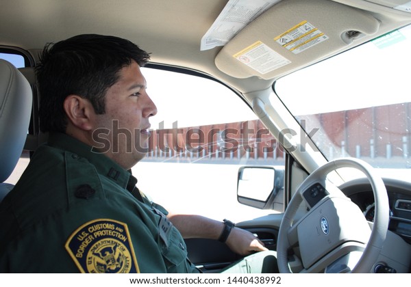 Yuma Sector, Ariz. / US -\
April 11, 2013: A Customs and Border Protection agent drives past a\
section of landing-mat fencing in the US-Mexico border wall.\
1570