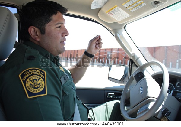 Yuma Sector, Ariz. / US -
April 11, 2013: A Customs and Border Protection agent drives past a
section of landing-mat fencing in the US-Mexico border wall.
1572