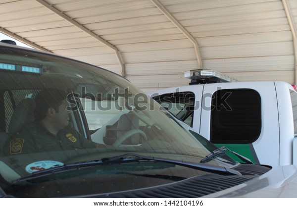Yuma Sector, Ariz. / US -\
April 11, 2013: Two Customs and Border Protection agent talk\
between their vehicles during a shift along the US-Mexico border.\
1756