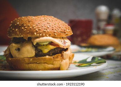 A Yummy Burger On A Plate, Homemade Fast Food . A Big Tasty Burger.