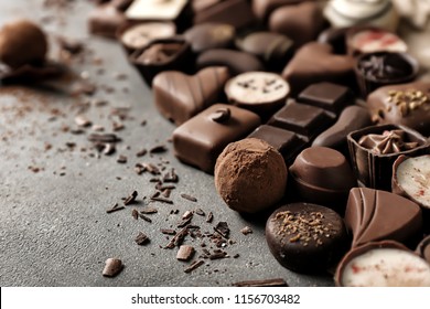 Yummy chocolate candies on grey background