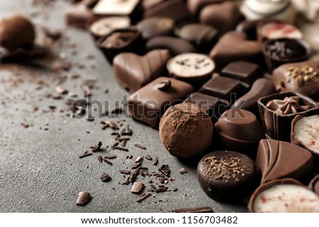 Yummy chocolate candies on grey background