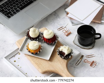Yummy Cupcakes Busy Office Desk With Stationery Scattered Yummy Cupcakes Busy Office Desk With Stationery Scattered