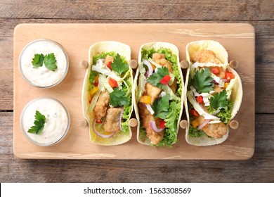 Yummy Fish Tacos Served On Wooden Table, Top View