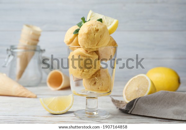 Yummy lemon\
ice cream served on white wooden\
table