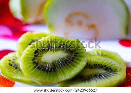 Yummy and mouthwatering kiwis fruit in the plate along with guava.