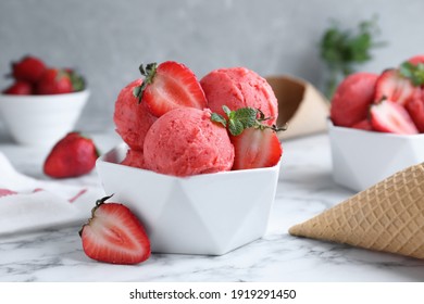 Yummy strawberry ice cream on white marble table