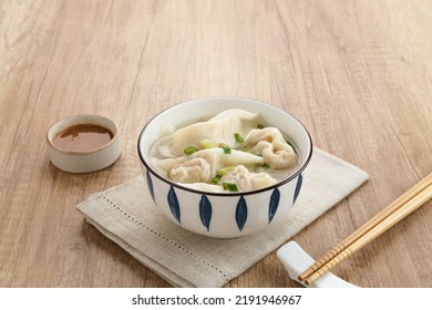 Yummy Wonton Soup (dumpling soup) or Pangsit Kuah served in bowl on dark background.
 - Shutterstock ID 2191946967