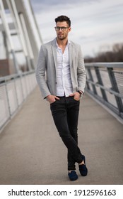 Yuppie Standing On The Bridge. Young Businessperson With Glasses Outdoors