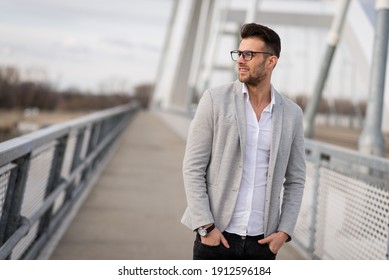 Yuppie Standing On The Bridge. Young Businessperson With Glasses Outdoors