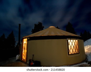 A Yurt In The Snowy Mountains At Night 