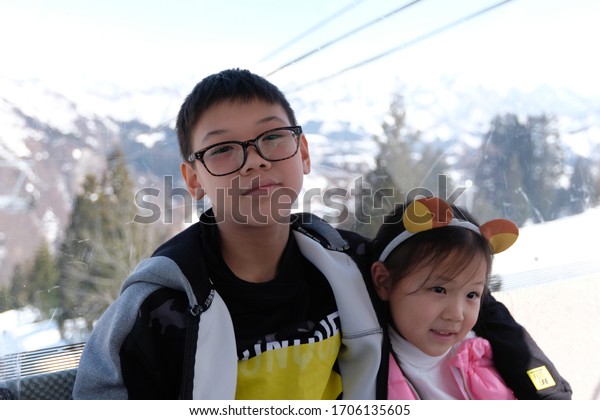  yuzawa japan mar\
18 2019 Asian brothers and sisters smiled happily in traveling with\
the ropeway in Japan.