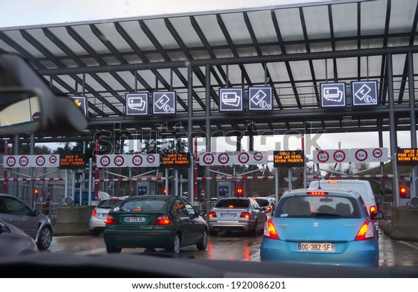 Yvelines, France - Dec. 2020 - Lines of car waiting\
to pay the fee, at the toll gate of the Highway Duplex A86, which\
gives access to the longest tunnel entirely in France, in the\
region of Paris
