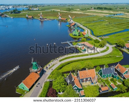 Zaanse Schans windmills and the famous Dutch canals near Amsterdam. Aero Photography. View from flying drone.Panoramic cityscape of old town of Zaandam, Netherlands, Europe. Top View