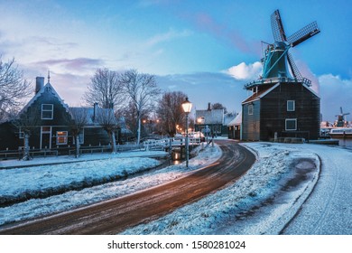 Zaanstad, Netherlands, January 30, 2015: Small mill and typical Zaanse houses on the Zaans Schans in winter located on the river De Zaan in the Netherlands