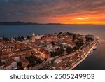 Zadar, Croatia - Aerial panoramic view of the Old Town of Zadar with Cathedral of St. Anastasia and a dramatic golden summer sunset at background