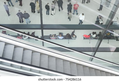 ZAGREB AIRPORT - 24 APRIL 2017: Aerial View Of Passengers Waiting In Hall, Escalators Passing.