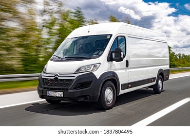 Zagreb, Croatia - April 22, 2018: Man is driving white Citroen Jumper delivery van driving fast on a motorway. 