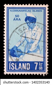 ZAGREB, CROATIA - JULY 03, 2014: A Stamp Issued In Iceland Shows Nursing For The Sick, 50th Anniversary Of Icelandic Nurses Association, Circa 1970.