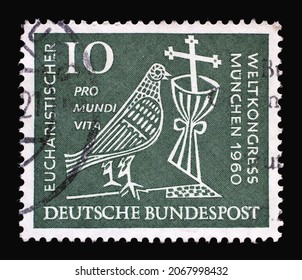 ZAGREB, CROATIA - JUNE 27, 2014: Stamp printed in Germany showing a stylized dove, cross and chalice. 37th Eucharistic World Congress in Munich, circa 1960
