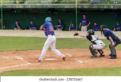 ZAGREB, CROATIA - MAY 03, 2015: Baseball Match Baseball Club Zagreb In Blue Jersey And Baseball Club Pirates In White Jersey. Baseball Batter Swing The Bat And Miss The Ball