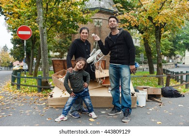 ZAGREB, CROATIA - OCTOBER 14, 2013: Roma Family Fooling Around For Camera At Garbage Dump.