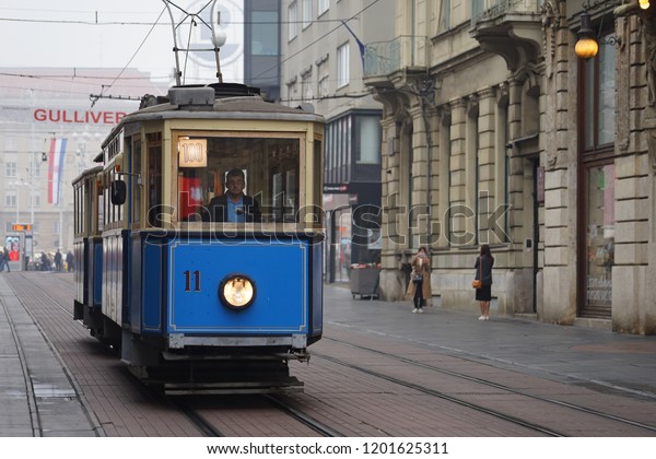 Zagreb / Croatia - October 2018: Tram of\
Railway as the vintage model is running on track in Zagreb\
downtown. Europe city life moment. Selected\
focus.