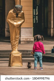 Zagreb/Croatia- 04 13 2018: Pantomime Dressed As An Egyptian Pharaoh Performs An Act For A Little Girl Who Is Mesmerized Watching It In Downtown Zagreb, Croatia