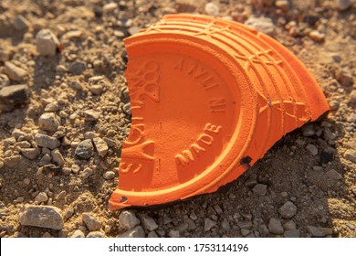 Zagreb/Croatia-June,7th,2020: Broken Clay Pigeon On The Gravel, Sand Floor In The Field After Being Shot Down During Shooting Practice With Firearm