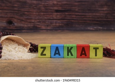 Zakat Or Islamic Tax Concept With Rice Coins And House Figure. Selective Focus Image. 