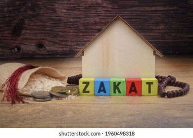 Zakat Or Islamic Tax Concept With Rice Coins And House Figure. Selective Focus Image. 