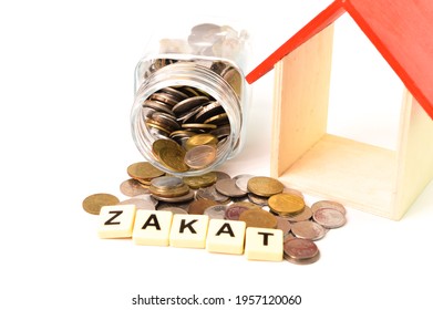 ZAKAT Word With Stack Of Coins And Toy House Isolated On A White Background