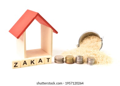 ZAKAT Word With Stack Of Coins, Toy House And Rice Isolated On A White Background