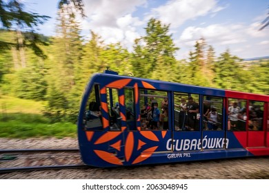 Zakopane, Poland - August 13, 2021: Pan Shot Of Funicular Railway At Gubalowka With Motion Blurred , Passengers Or Tourist Traveling Inside Cable Car Wearing Protective Mask As Covid Precaution