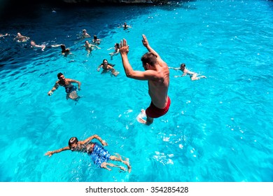 Zakynthos, Greece - August 11, 2015: Tourists enjoying the clear water of Zakynthos island, in Greece. Navagio Beach is a popular attraction among tourists visiting the island of Zakynthos
