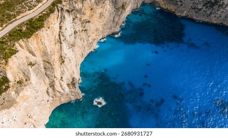 Zakynthos Greece dramatic limestone cliffs rising above deep blue Ionian Sea with shoreline and transparent turquoise water below