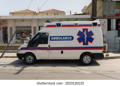 Zakynthos, Greece - July 9 2021: Greek Emergency Care private ambulance on street. Hellenic EMS medical paramedic services car parked on a Laganas village road at the Ionian islands.