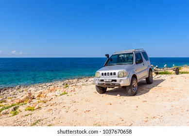 ZAKYNTHOS, GREECE - October 1, 2017: Suzuki Jimny Car Parked In Porto Roxa, Rocky And Quiet Beach On The Coast Of Zakynthos Island. Greece