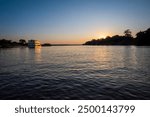 Zambezi sunset boat cruise on the Zambezi River at Victoria Falls, Mosi-oa-Tunya, is a waterfall on the Zambezi River, located on the border between Zambia and Zimbabwe.