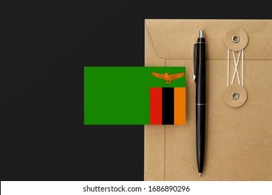 Zambia Flag On Craft Envelope Letter And Black Pen Background. National Invitation Concept. Invitation For Education Theme.