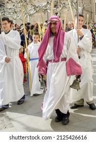ZAMORA, SPAIN - APRIL 10, 2006: EL Barandales, character that appears in all the Holy Week processions in Zamora, Spain. Borriquita procession. Focus on the altar servers around you.