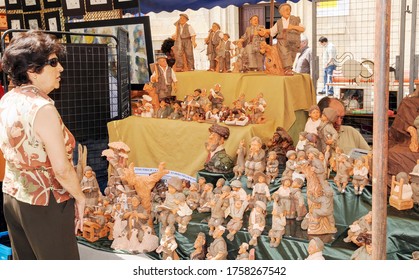 Zamora / Spain-June 26, 2010: Pretty Human-shaped Clay Figures Admired By A Woman At A Booth At A Ceramic Craft Fair In Zamora.