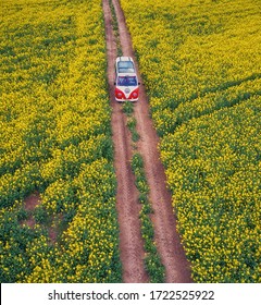 Zamosc, Poland 5.05.2020: Hippie van in the middle of a field of blooming rapeseed