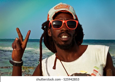 Zanzibar, Kiwengwa - 15 January, 2015: a portrait of a cool reggae and rastaman on the beach of Zanzibar, with dreadlocks and sunglasses